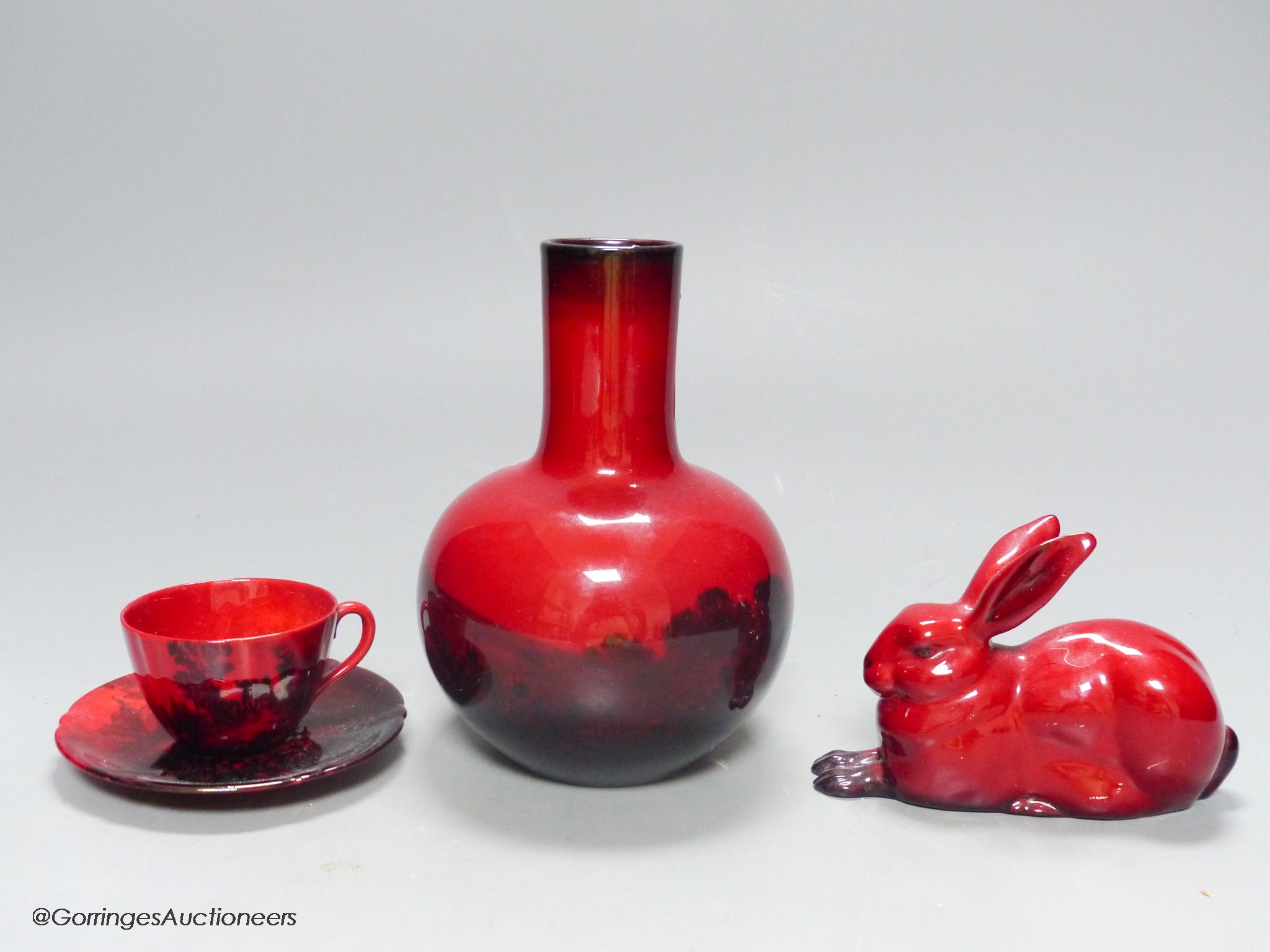 Royal Doulton flambe ware, consisting: a vase, a cup and saucer and a model of a hare (4)